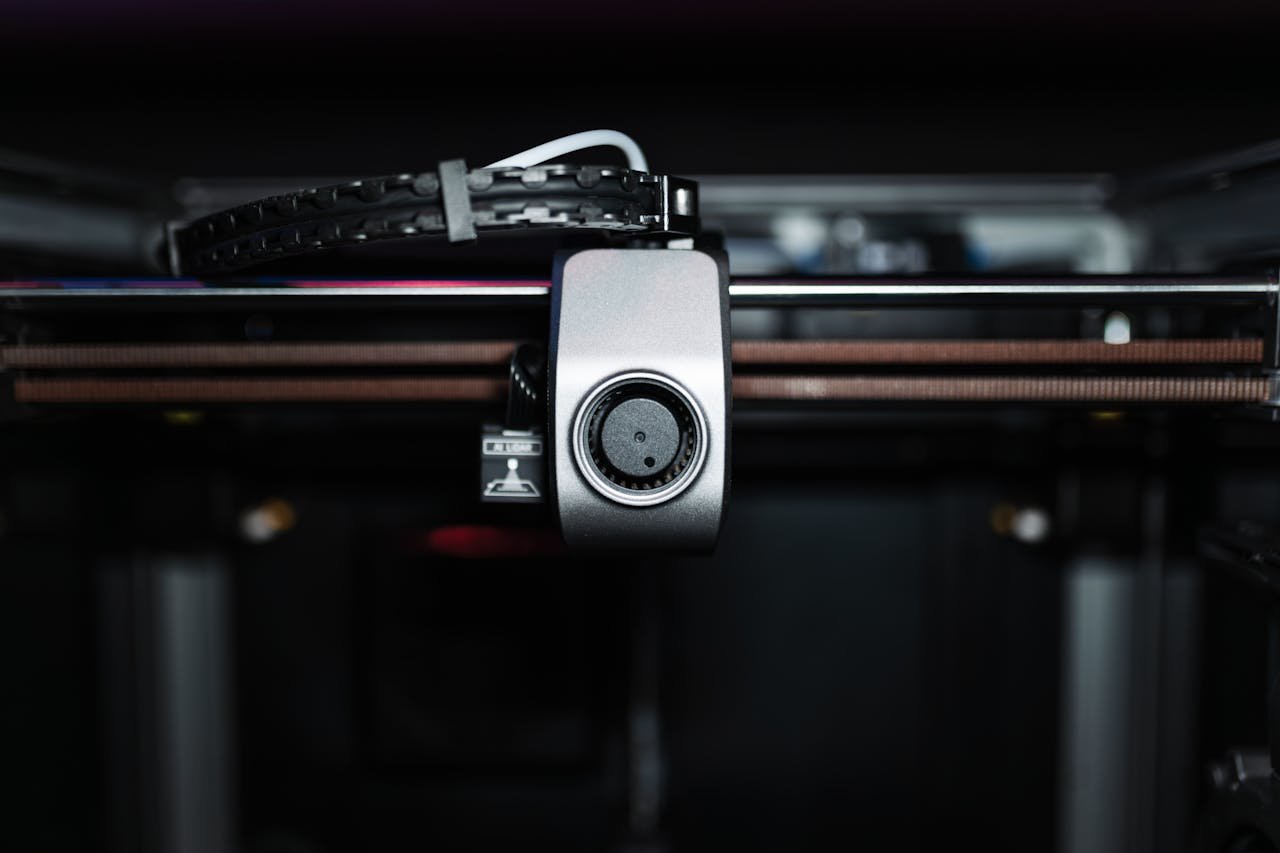 Macro shot of a 3D printer nozzle highlighting technology and precision.